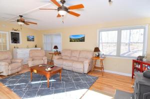 a living room with two couches and a ceiling fan at Bear Necessities -Forget your Worries! in Great Cacapon