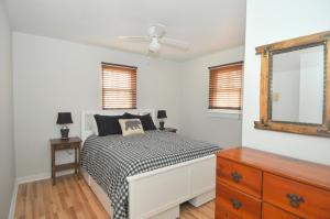 a bedroom with a bed and a dresser and a mirror at Bear Necessities -Forget your Worries! in Great Cacapon