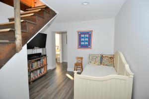 a living room with a white couch and a staircase at River View Cabin - Mountain Views in Morton Grove