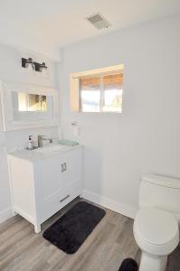 a white bathroom with a toilet and a sink at River View Cabin - Mountain Views in Morton Grove +53 photos