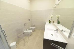 a white bathroom with a sink and a toilet at Ferienwohnung für 4 Personen ca 75 qm in Imperia-Porto Maurizio, Italienische Riviera Italienische Westküste in Imperia