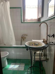 a bathroom with a sink and a bath tub at Guest House Torre Guelfa, Vinsantaia in Figline Valdarno