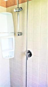 a shower in a bathroom with a toilet at Hotel Ciao Bed & Breakfast in Lignano Sabbiadoro