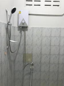 a shower in a bathroom with a shower head at Grace Hostel in Khon Kaen