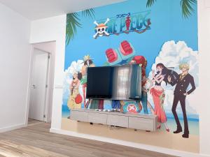 a living room with a tv and a wall mural at ONE PIECE Apartamento con patio in Alcobendas
