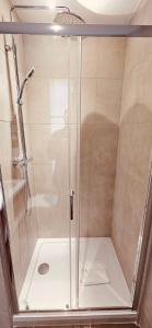 a shower with a glass enclosure in a bathroom at HOTEL FORMIO in Paris