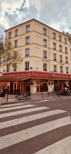 巴黎的住宿－HOTEL FORMIO，一座大型建筑,前面停放着自行车