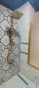 a shower in a bathroom with a tile wall at Ktisis Butik Otel in Urfa