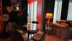 - un salon avec une table en verre et un canapé dans l'établissement Bienvenue chez Maxime, à Saint-Denis