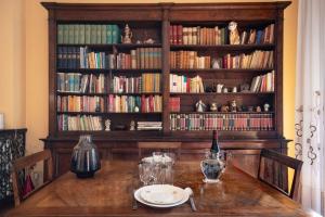 una mesa de comedor con una estantería llena de libros en Ferienwohnung für 4 Personen ca 98 qm in Sesto Fiorentino, Toskana Provinz Florenz, en Sesto Fiorentino