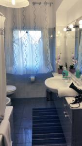 a bathroom with a sink and a toilet and a shower at Casa Vacanze Milosa in Terme Vigliatore +41 photos