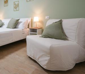a living room with a white couch and a lamp at Alice al Mare in Pescara +20 photos