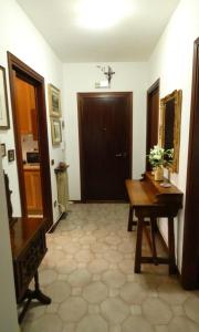 a hallway with a wooden table and a door at Lily Rose House in Venice