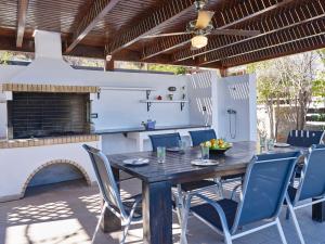 a wooden table and chairs on a patio at Ferienhaus in Vlycha Beach mit privatem Pool und herrlicher Aussicht in Líndos