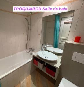 a bathroom with a sink and a toilet and a tub at MAISON DES VIGNES- TROQUAÏROU et BECCA MOTTA in Brides-les-Bains