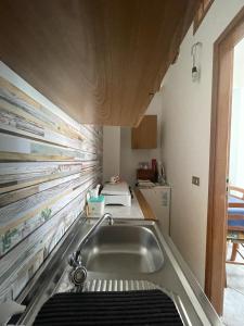 a kitchen with a sink and a counter at Case Vacanza Trappetodavivere in Trappeto