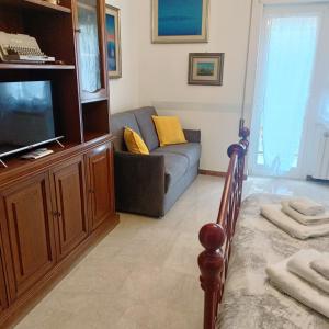 a living room with a couch and a tv at The Pope At The Window in Rome