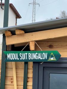 a street sign hanging outside of a building at Modul Suit & Bungalov in Rize