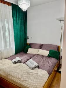a bed with two pillows on it in a room at Przytulny apartament in Augustów