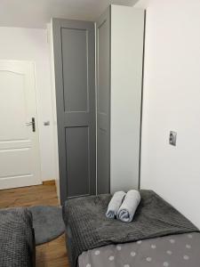a bedroom with a bed with two towels on it at Przytulny apartament in Augustów +1 photo