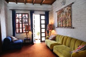 a living room with a couch and a painting on the wall at Boutique Hotel Antinea in Quito