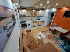 a living room with a couch and a table at Apartman Borsalino Subotica in Subotica