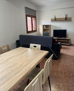 a living room with a table and a couch at Apartamento JUMIDOSIV in Aliaga