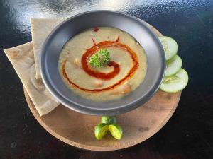 a bowl of soup with broccoli in the middle at Mojo Hostel in Puerto Princesa City