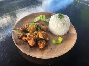 a plate of food with rice and broccoli on a table at Mojo Hostel in Puerto Princesa City
