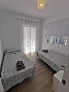 מיטה או מיטות בחדר ב-La Perla de Monte y Mar