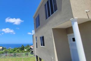 a building with a view of the ocean at Château Charles, Coubaril, stunning Ocean view a 12 min drive to Vigie Beach in Castries