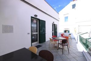 a patio with a table and chairs on a balcony at Appartamenti Amalfi Vista Mare in Amalfi