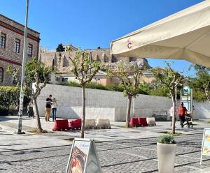 a group of people walking on a street with trees at Elegant Apt 50meters Close Acropolis in Athens