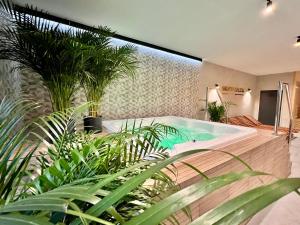 a bath tub in a room with plants at SILVER BALTIC in Kołobrzeg