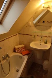 a bathroom with a sink and a toilet and a bath tub at Ferienwohnung-zum-Kueppchen in Münstermaifeld