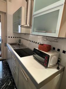 a kitchen counter with a microwave and a sink at Palma Residence Rapallo by PortofinoVacanze in Rapallo +58 photos