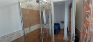 a glass shower in a room with a hallway at NEN's House in Alghero +31 photos