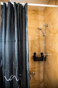 a shower with a black shower curtain in a bathroom at Apartman Mina 4 in Vrdnik +20 photos