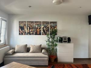 a living room with a couch and a picture on the wall at Appartement Wörthersee in Klagenfurt