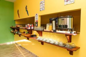 a kitchen with shelves with food and drinks on it at Lençóis Maranhenses - 2 Hóspedes + Café da manhã in Barreirinhas +43 photos