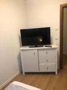 a white dresser with a flat screen tv on top of it at 4 Zimmer-Komfortwohnung mit viel Platz in Haltern in Haltern