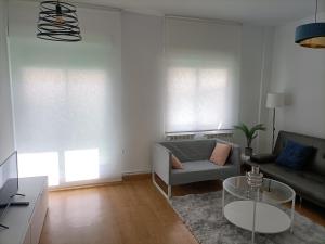 a living room with a couch and a table at Céntrico apartamento reformado de dos habitaciones in Logroño