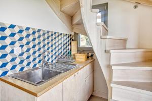 a kitchen with a sink and a staircase at Kumquart estate- Grape fruit in Aspiotádes