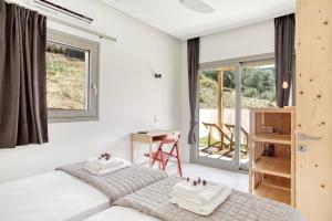 a bedroom with two beds and a desk and windows at Kumquart estate- Grape fruit in Aspiotádes