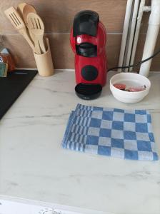 a red coffee maker sitting on top of a kitchen counter at l'Impérial A - Gare RER à pieds in Étampes