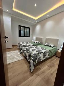 a bedroom with two beds in a room at Novospace Sousse , Sahloul S+3 in Sousse