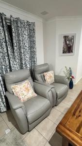 a living room with a couch and a chair at Bickley Street in Perth