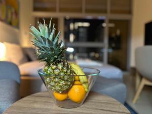 a glass bowl with a pineapple and oranges on a table at Dubai 7 in Dubai