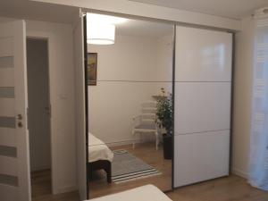 a mirrored closet in a room with a mirror at Przy Parku in Wyszków