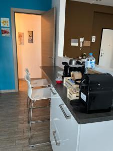 a kitchen with a counter top with a printer on it at Pole Position Rho - Milano a portata di mano in Rho